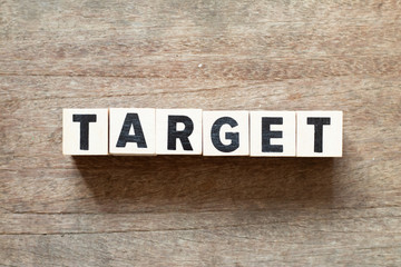 Fototapeta premium Letter block in word target on wood background