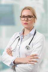 young female doctor in lab coat with stethoscope