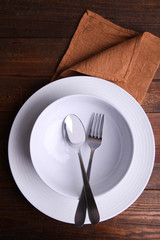 Two clean plates and cutlery