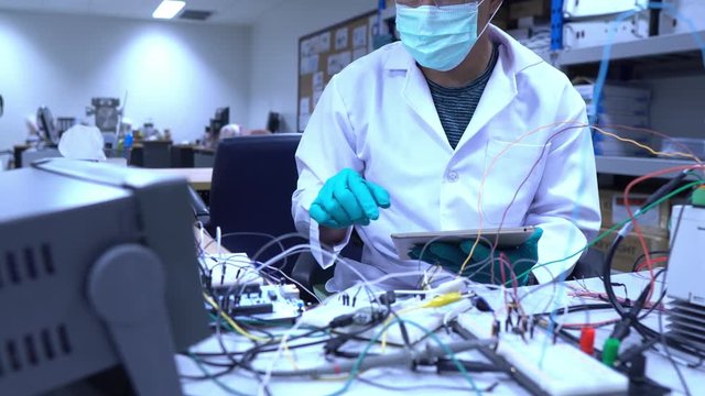 Scientist working in the lab,Highly skilled scientists and engineers are in a position to check the operation of the new project.