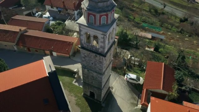 CRNI KAL, SLOVENIA, 2017.08.22: Aerial: Small village under rocky Karst hill. Filming beautiful country at Slovenian seaside region.
