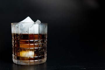 Refreshing black soda soft drinks with ice in a clear glass