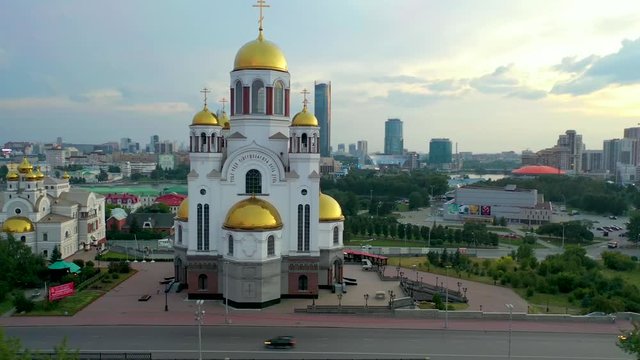 Yekaterinburg city center in the evening, temple on the blood , the pond and the business center in the background, fly around the temple