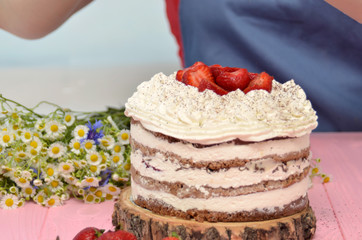 Tiramisu homemade cake. Italian dessert consisting of layers of sponge cake soaked in coffee and brandy or liqueur with powdered chocolate and mascarpone cheese.