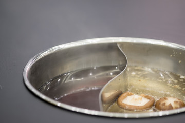 Double flavor hot pot in hot pot buffet (black soup and mushroom soup)