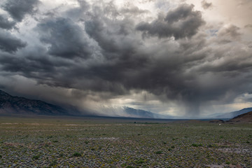 Storm clouds and rain in the distance at Alabama Hills in California 