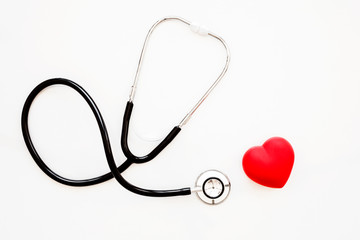 Red heart and a stethoscope on white background