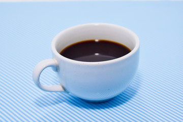 Coffee cup, blue pattern background