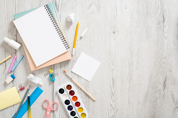 School supplies frame on wooden background. Flat lay, top view. Back to school concept.