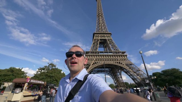 Man taking selfie with a view on Eiffel Tower in Paris in 4k slow motion 60fps