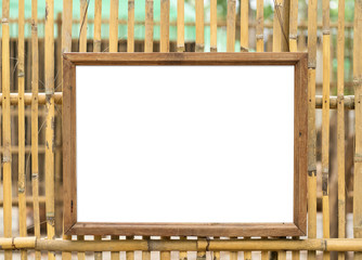 Blank white wooden photo frame on bamboo wall background