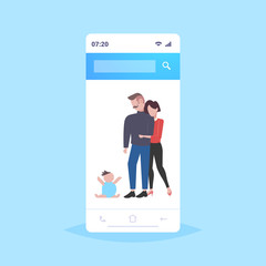 parents embracing and looking at newborn baby sitting on floor happy family having fun together parenthood concept father mother playing with little kid smartphone screen mobile app full length