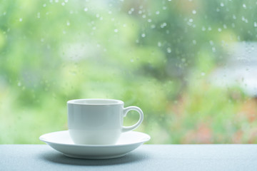Fototapeta premium White coffee cup on a rainy day