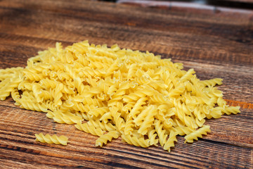 spaghetti, fusilli, macaroni, pasta traditional Italian on wooden background close up selective focus