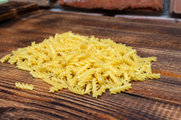 spaghetti, fusilli, macaroni, pasta traditional Italian on wooden background close up selective focus