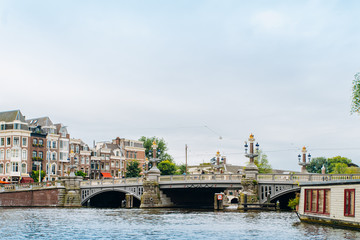 Naklejka premium Amsterdam, Netherlands September 5, 2017: Magere Brug Bridge and Amstel river.