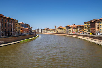 Cityscape view of Arno River in Pisa city old town in a sunny day, Italy