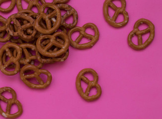 salty bretzel food pattern on a pink background