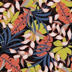 Trend seamless pattern with colorful tropical leaves and plants on a dark background. Vector design. Jungle print. Flowers background. Printing and textiles. Exotic tropics. Fresh design.