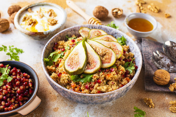 close-up view of tasty healthy couscous salat with figs fruits, nuts and pomegranate seeds 