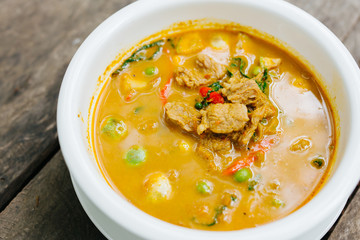 Red Curry with Pork on wooden table top view, Thai local food