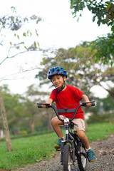 Fototapeta premium Cheerful Little Boy Riding a Bike