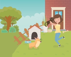 woman with cute little cat and dog in the house garden