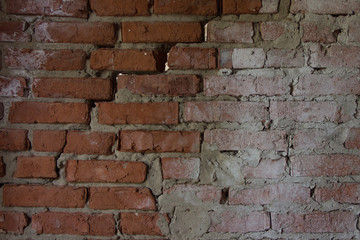 The structure of the old brickwork with a crack diagonally. The wall, the background