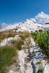 Fototapeta na wymiar Turkey, panoramic view of travertine terraces at Pamukkale (Cotton Castle), natural site of sedimentary rock deposited by water from the hot springs, famous for carbonate mineral left by flowing water