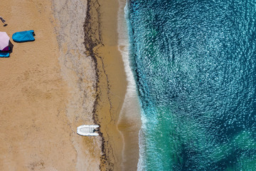 Aerial view of a boat on water and sandy coastline view