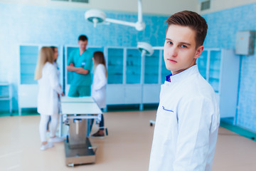 Portrait of a doctor intern. Medical students profession staff. multinational people - doctor, nurse and surgeon. A group of graduates of a medical university in a surgical room.