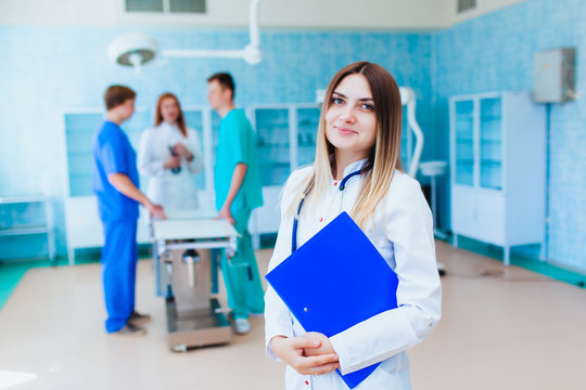 Portrait of a doctor intern. Medical students profession staff. multinational people - doctor, nurse and surgeon. A group of graduates of a medical university in a surgical room.