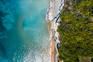 Aerial view of beautiful green rocky Island. Rocky cliffs in the ocean seen from above.. 