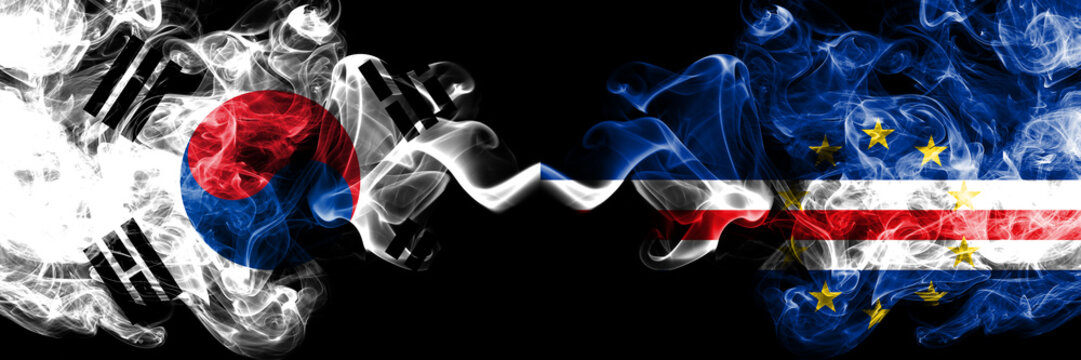 South Korea vs Cape Verde smoky mystic flags placed side by side. Thick colored silky abstract smoke flags of South Korean and Cape Verde