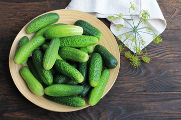 Farm cucumbers on wooden background. Close-up, copy space.