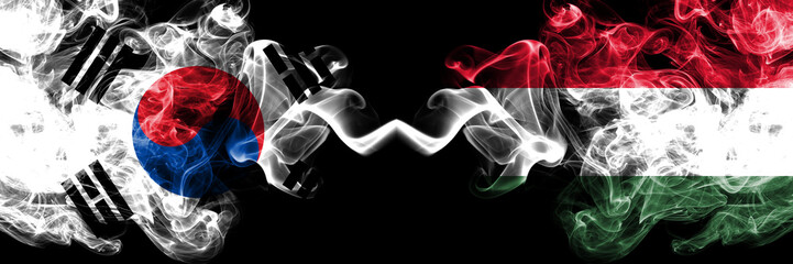 South Korea vs Hungary, Hungarian smoky mystic flags placed side by side. Thick colored silky abstract smoke flags of South Korean and Hungary, Hungarian