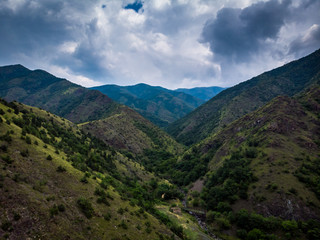 Fototapeta premium Aerial view of mountain and forest, cloudy day. Near the Ibar river and Maglic castle in Serbia