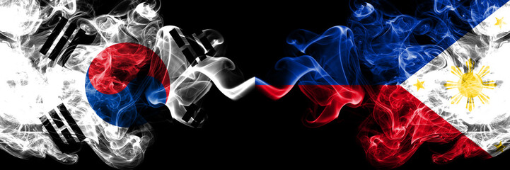 South Korea vs Philippines, Filipino smoky mystic flags placed side by side. Thick colored silky abstract smoke flags of South Korean and Philippines, Filipino