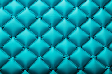Texture of a blue inflatable tourist rug, repeating sections and patterns. Air mattress Ultralight Portable rug.