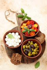 Mediterranean snack - mozzarella, olives,cherry tomatoes and basil leaves