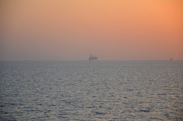 Sunset in persian gulf with oil platform