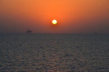 Sunset in persian gulf with oil platform