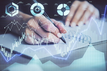 Forex graph on hand taking notes background. Concept of research. Multi exposure