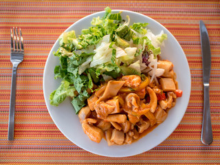 Top view of plate full of sea food and green salad