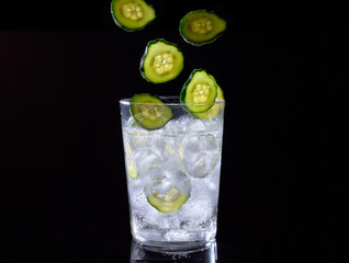 Cucumber water on black background.