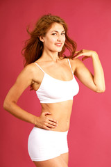 Young beautiful blonde woman in white fitness clothing