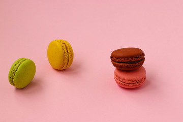 Colorful french cookies macaroons on pink background, Copy space, horizontal photo