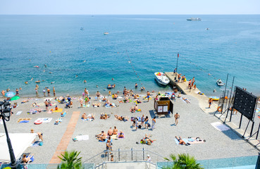 Tourists relax on vacation at the Central beach in Yalta