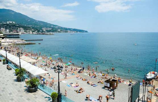 Tourists relax on vacation at the Central beach in Yalta