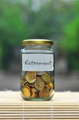 Coins in bottle with label Retirement - financial concept
